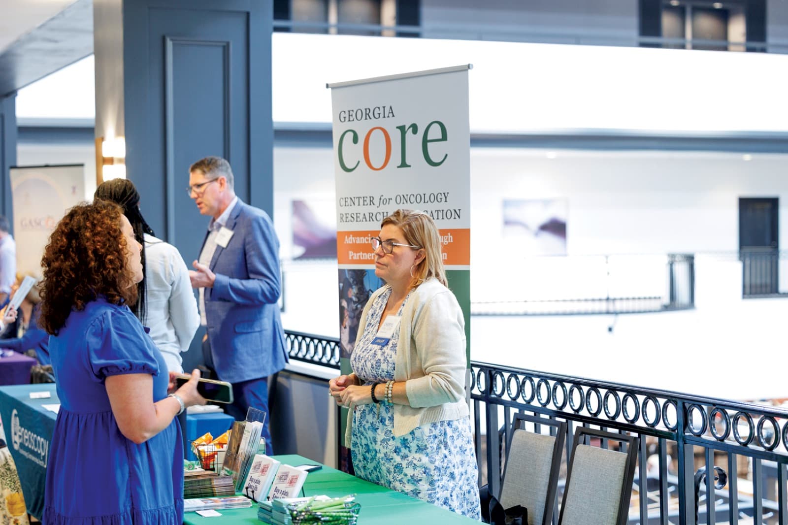 Georgia CORE staff talking with visitors at a community event